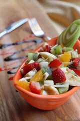 Fresh Fruit Salad in Red Bowl on Dark Background