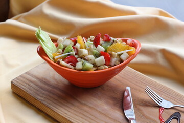 Fresh Fruit Salad in Red Bowl on Dark Background