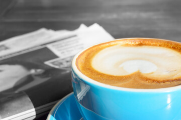 Morning coffee over newspaper. Selective color.