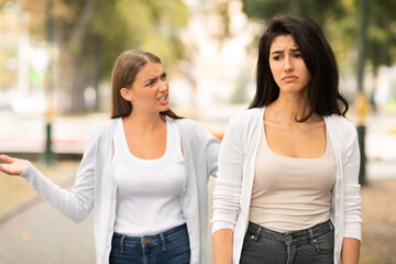 Two Girls Friends Having Quarrel Walking In Park Outdoors