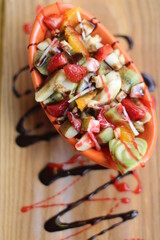 Fresh Fruit Salad in Red Bowl on Dark Background