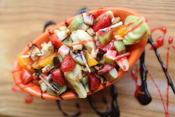 Fresh Fruit Salad in Red Bowl on Dark Background