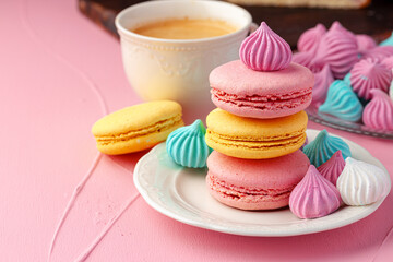 Cup of coffee with colorful cookies close up