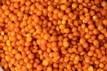 Dry uncooked red lentils grain texture background