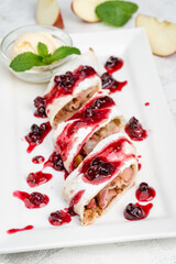 Apple strudel with syrup and ice cream