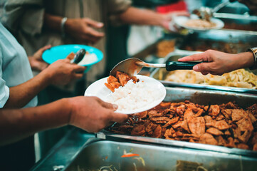 The hands of beggars receive donated food : The concept of food shortages