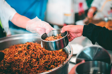 The hands of beggars receive donated food : The concept of food shortages