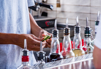 Bartender with cucumbers for garnish