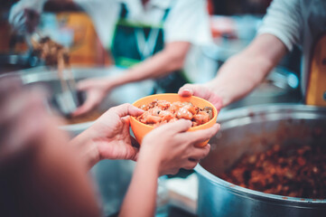 The hands of beggars receive donated food : The concept of food shortages