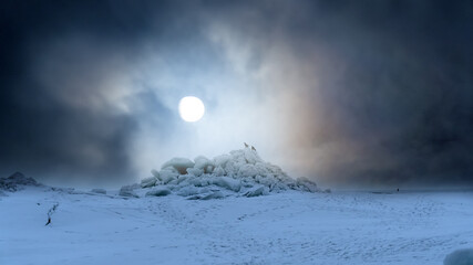 Huge ridge of ice hummocks after a powerful winter storm. Climate and weather change