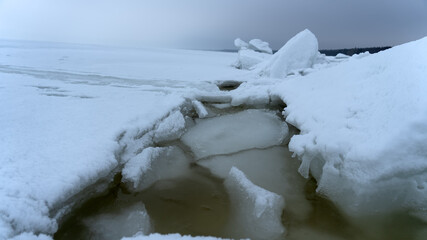 Huge ridge of ice hummocks after a powerful winter storm. Climate and weather change