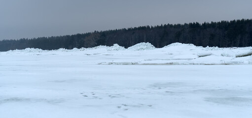 Huge ridge of ice hummocks after a powerful winter storm. Climate and weather change