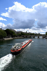 Obraz premium Long red barge on the Seine river in Paris