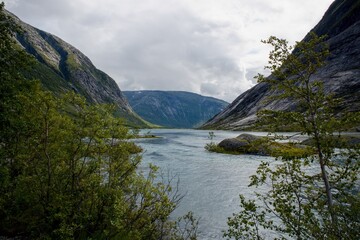 Scenic view of Nigardsbrevatnet lake surrounded by mountains - Jostedalsbreen national park, Norway