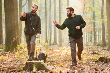 Two hunters with a hound as a sweat dog