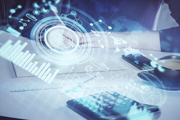 Double exposure of hands and notepad with business icons.