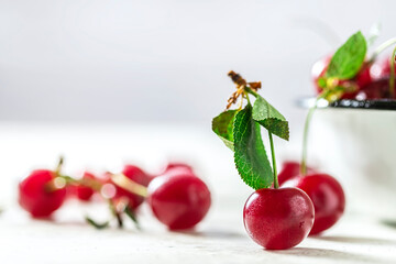 Close up image of sweet cherry on a light concrete background.