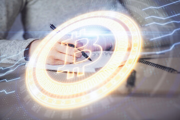 Cryptocurrency hologram over woman's hands writing background. Concept of blockchain. Multi exposure