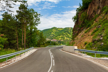 Empty mountain curvy road with guardrail