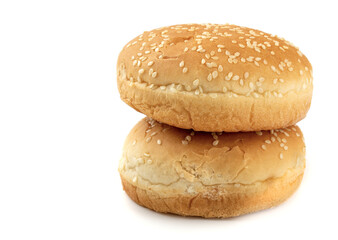 sesame buns for hot dogs on a white isolated background, close-up