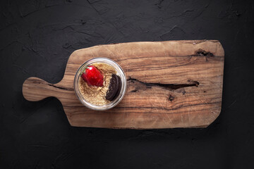 Fruit cake on tumbled stone floor and wooden presentation