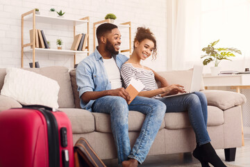 Happy Couple Using Laptop Booking Hotel For Vacation At Home