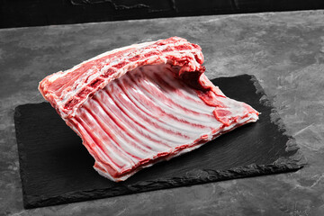 Lamb ribs fresh meat, with eco-friendly packaging. Food Delivery Concept. copy space, dark...