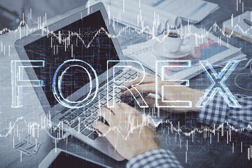Double exposure of forex graph with man working on computer on background. Concept of market analysis.