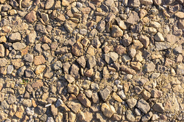 background stones, yellow cobbles texture of the road