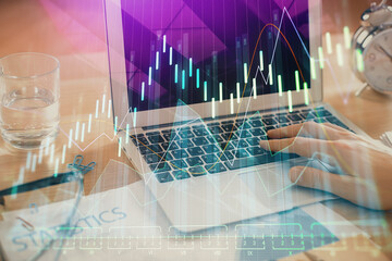Multi exposure of market chart with man working on computer on background. Concept of financial analysis.