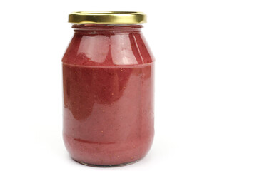 Glass jar with strawberry or raspberry jam isolated on the white background