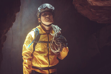 Fototapeta na wymiar Cave explorer or climber with rope equipment