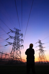 Electricity workers and pylon silhouette, Power workers at work