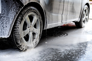 Car washing. Cleaning car using high pressure water. Contactless self-service car wash. Concept disinfection and antiseptic cleaning of the vehicle. Russia, Rostov-on-Don 06.12.2020