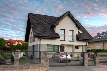 A modern single family house with a garden at sunset