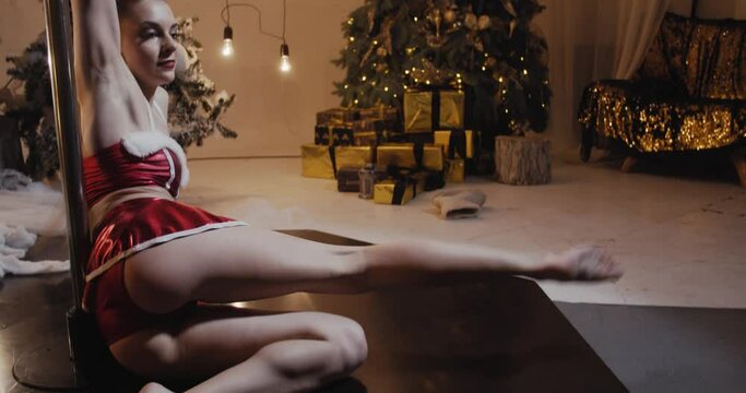 Sexy woman in Christmas outfit is poke dancing on the floor, 4k