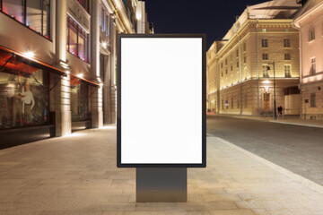 Blank street billboard poster mockup at night. Isolated with clipping path around advertising.