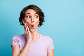 Portrait of astonished crazy girl impressed incredible rumor gossip novelty look copyspace touch hands face wear casual style clothes isolated over blue color background