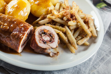 Pork rolls stuffed with vegetables served with potatoes