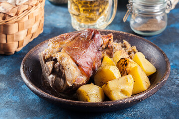 Pork knuckle with fried sauerkraut and baked potatoes