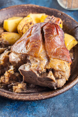 Pork knuckle with fried sauerkraut and baked potatoes