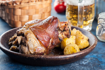 Pork knuckle with fried sauerkraut and baked potatoes