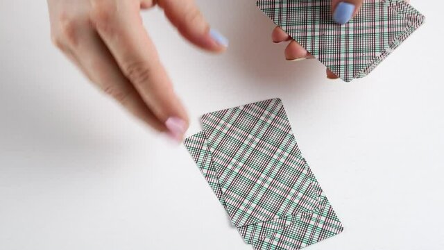 Deals the cards to three.The deck lies on the table face down.