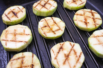 fried zucchini in a square grilled pan