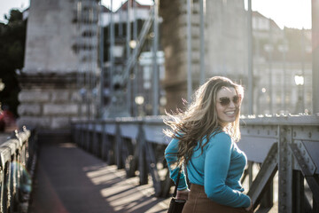 Blonde girl is walking on the bridge