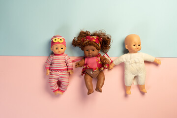 Baby dolls lying on colorful background