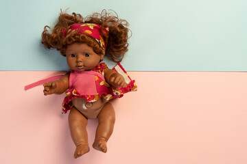 Baby doll lying on colorful background