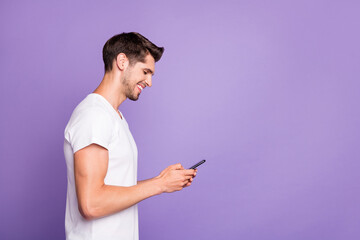 Profile side view portrait of his he nice attractive cheerful cheery focused guy using cell...