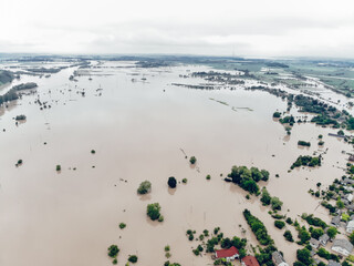 Climate change and the effects of global warming. Flooded village, farms and fields after heavy...