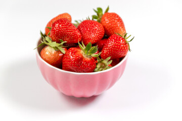 Bowl with fresh strawberries on white background. Summer composition